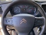 the interior of a car with a steering wheel and dashboard controls