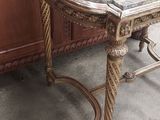 a small table with a marble top on the floor
