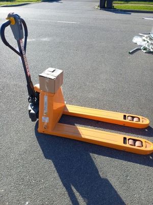 a pallet that is sitting on the ground with a pair of scissors