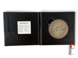 a picture of a gold medal in a black box