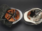 two helmets that are sitting on a table