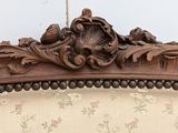 a close up of a wooden frame on a couch