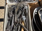 many different types of utensils and spoons in a container
