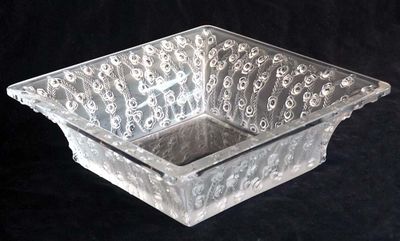 a clear glass bowl with a design on it
