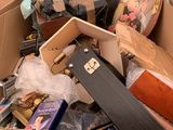 a cardboard box filled with luggage and other items