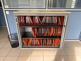 a metal cabinet with a bunch of orange folders on it