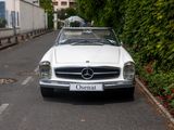 a white car that is parked on the side of the road