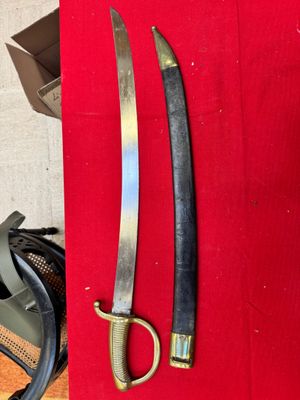 two swords that are on display on a red cloth