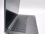 a laptop computer that is sitting on a white surface