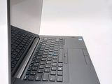 a laptop computer that is open on a white surface