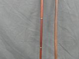 two old canes are sitting next to each other on a gray surface