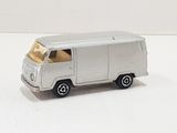a silver toy van that is on a white surface