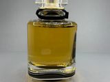 an image of a bottle of perfume sitting on top of a table