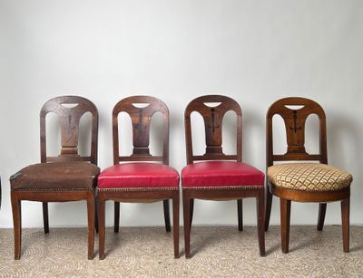 four wooden chairs are lined up against a wall in a row