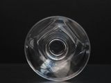 an image of a clear glass object on a black surface