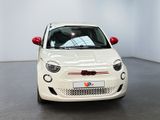 a small white car that is parked in a room