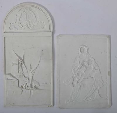 two white reliefs of a woman and a man on a boat