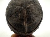 wooden sculpture of a woman ' s head on a wooden stand