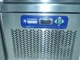 a stainless steel refrigerator with a blue sign on it