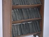 a wooden book shelf with a lot of books on it