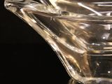 clear glass bowl sitting on top of a black surface