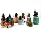 a lot of different colored vases on a white surface