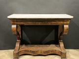 a wooden table with a marble top on top of a wooden floor