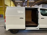 a white van with its doors open in a warehouse