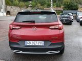 a red car that is parked on the side of the road