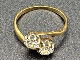 an image of a close up of a gold ring on a table