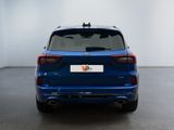 the rear end of a blue bmw suv parked in a room