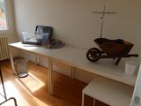 a desk with a wheelbarrow and a laptop on it