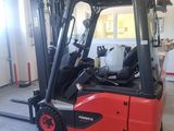 a red fork truck parked inside of a building