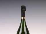 a bottle of champagne on a table with a white background