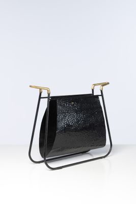 a black leather magazine holder on a white surface