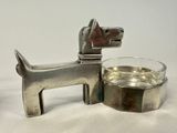 a silver dog with a glass of water next to it