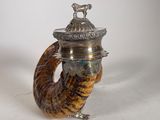 an image of a silver and horn shaped teapot with a bird on top