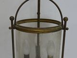 a glass lantern with a bird on top of it