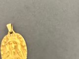 a gold coin with the face of jesus on it