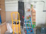 many boxes and ladders in a garage with boxes on the floor