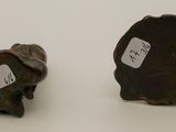 pair of bronze figurines of elephants on a white surface
