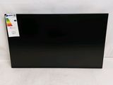 the back of a black television sitting on top of a white surface