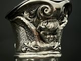 a glass vase with a silver decoration on it