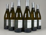 six bottles of wine are lined up in a row on a table