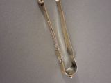 two spoons and a spoon rest on a table