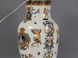 a white vase with a blue and yellow design on it