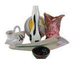 a glass plate with a vase and a bowl on it