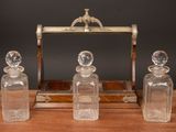 three glass bottles sitting on top of a wooden table