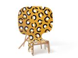 yellow chair with black and white circles on it on a white background