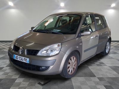 a picture of a small silver car parked in a garage